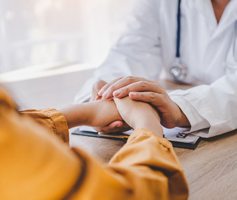 Doctor holding patient's hands