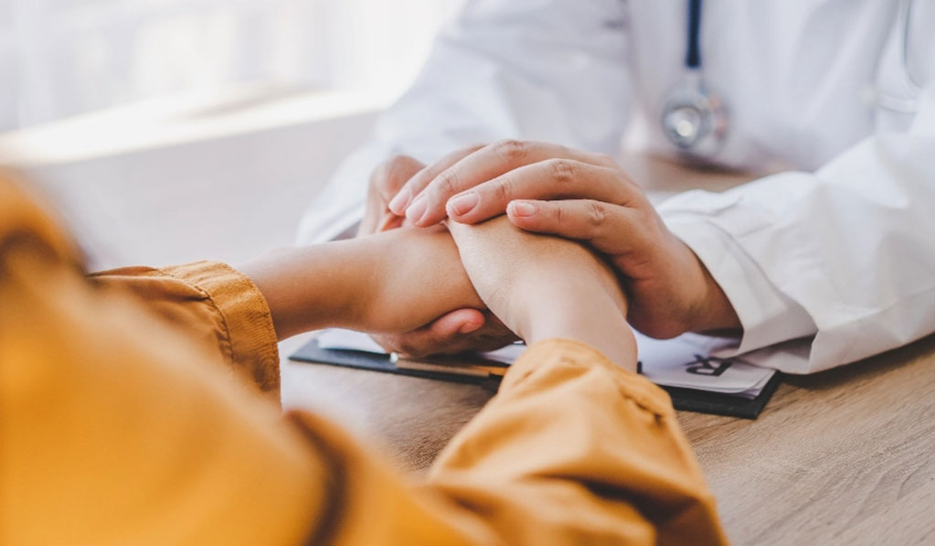 Doctor holding patient's hands